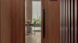 A modern interior with wooden paneling, a mirrored wall, and a sign reading "COWORK". - Top Rentals Palermo Soho (Buenos Aires)
