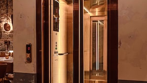 An elevator with a metallic finish, a digital display, and a glass panel. - Stone Inn Galata (Istanbul)