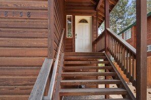 A wooden staircase leading to a white door with a window above it. - Kings Beach Bliss | Walk to Outdoor Fun! (Kings Beach)