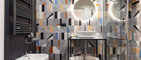 A modern bathroom with a white sink, a bidet, and a glass-enclosed shower.
