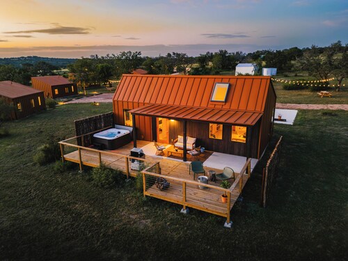 Luxury cabin in the TX Wine Country with porch, hot tub, grill and fire pit.