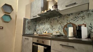 A kitchen with a microwave, toaster, and a basket on the counter.