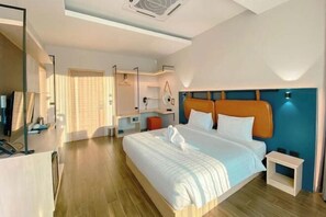 A modern hotel room with a large bed, a bedside table, a mirror, and a wardrobe. - The Posh Khao Kho (Khao Kho)