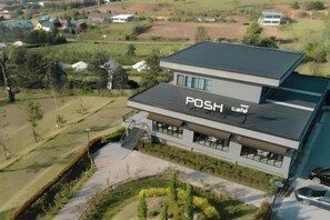 A modern two-story building with a flat roof and a sign that reads 'POSH cafe'. - The Posh Khao Kho (Khao Kho)