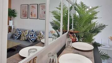 A modern bathroom with a large mirror, two sinks, and a wooden vanity.