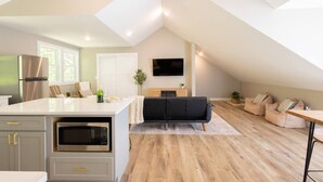 A modern loft apartment with a kitchen, dining area, and living space. - The Cottage, Rusted Route Farms (Jackson)