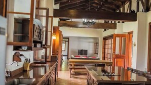Una habitación tradicional japonesa con suelo de tatami, una mesa baja y puertas correderas.