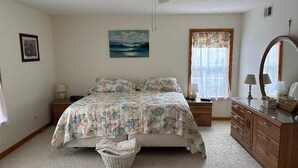 A bedroom with a bed, dresser, nightstands, and a ceiling fan. - Anchored At Last 3-bed Condo Kill Devil Hills w/ Large Deck and View of the Pool (Kill Devil Hills)