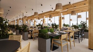 A modern restaurant with wooden tables and chairs, large windows, and hanging pendant lights.