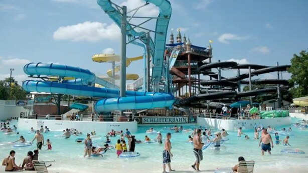 A water park with multiple water slides and a swimming area. - Ocean & Pool View Top Floor | 2 Pools| HotTub |GYM (Galveston)