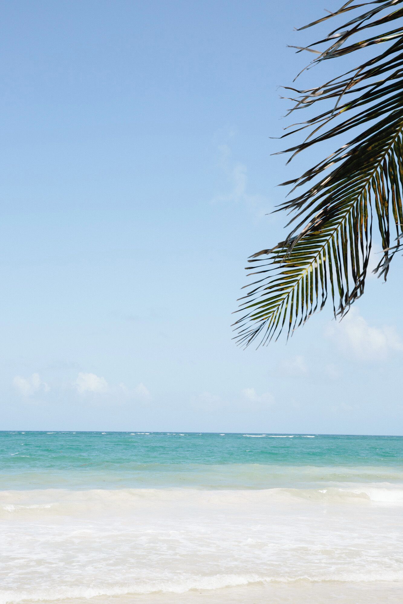 A beach with clear turquoise water and white sand.