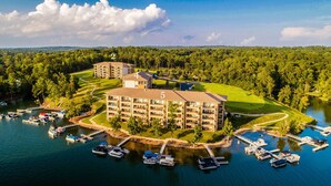 A multi-story hotel with a golf course and marina. - Stoneview Lakeside Dreams, 3BR Stillwaters Lake Condo (Alabama)