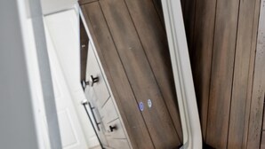 A wooden door with a handle and a small circular sticker.