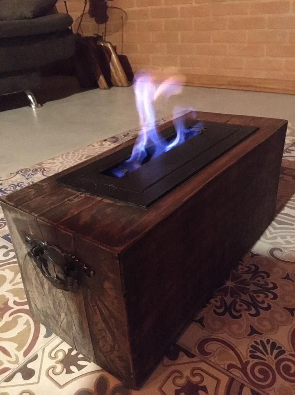 A wooden box with a built-in electric fireplace.