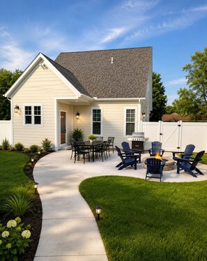 A house with a patio, outdoor seating, and a fire pit.