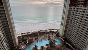A resort with a pool area, beach access, and high-rise buildings.