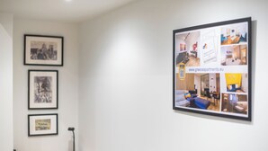 A framed collage of apartment interiors on a wall, including a desk with a lamp and framed pictures. - PetraLab By Greece Apartment (Athens)