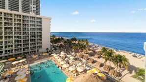 A hotel with a pool area, beach, and ocean view. - Balcony on the Ocean Picture Perfect (Sunny Isles Beach)