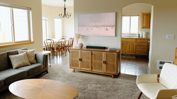A living room with a sofa, a coffee table, and a dining area with chairs and a table. - Spacious 5-bedroom townhome in Moscow (Moscow)