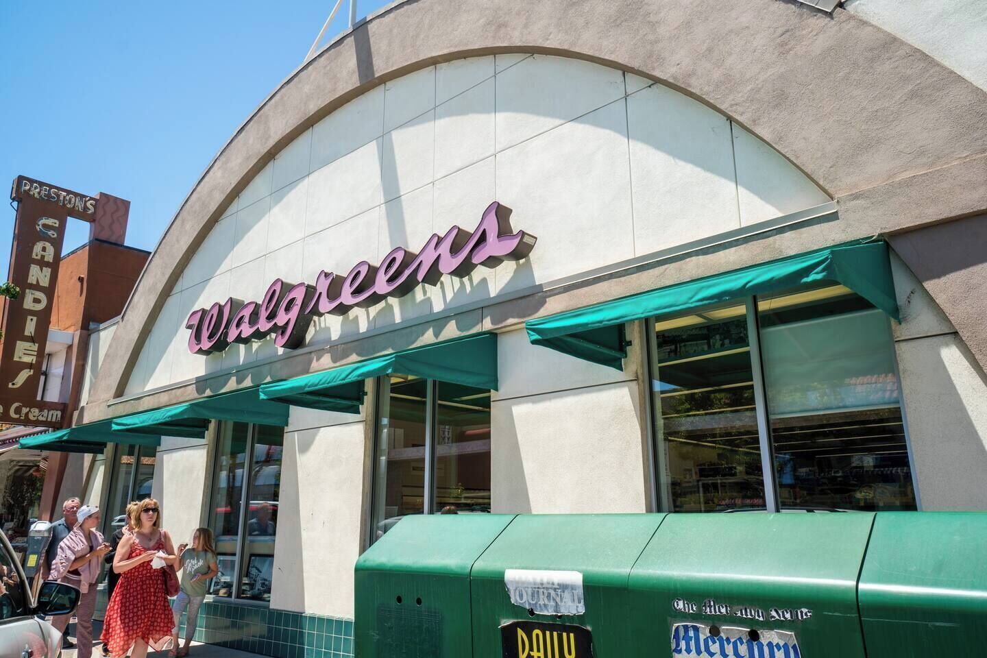 A Walgreens store with a distinctive arched entrance and green awnings.