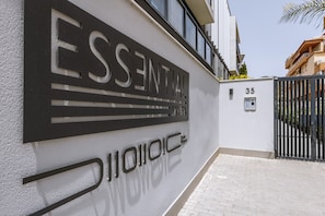A building facade with the name "ESSENTIAL" and a gate number "35".