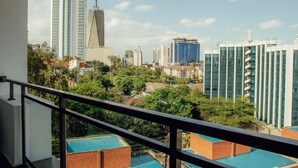 A cityscape with modern high-rise buildings, a mix of greenery, and a clear sky. - 1 bedroom spacious, modern and cozy apartment nestled in upperhill nairobi Kenya (Nairobi)