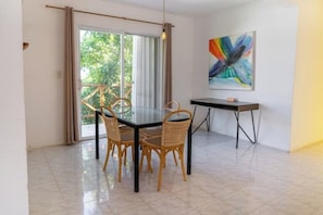 Enjoy a meal at the round dining table with four chairs, or step out onto the balcony through the glass door.