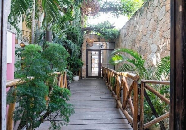 Stroll through lush gardens to the serene entrance of this tranquil retreat.