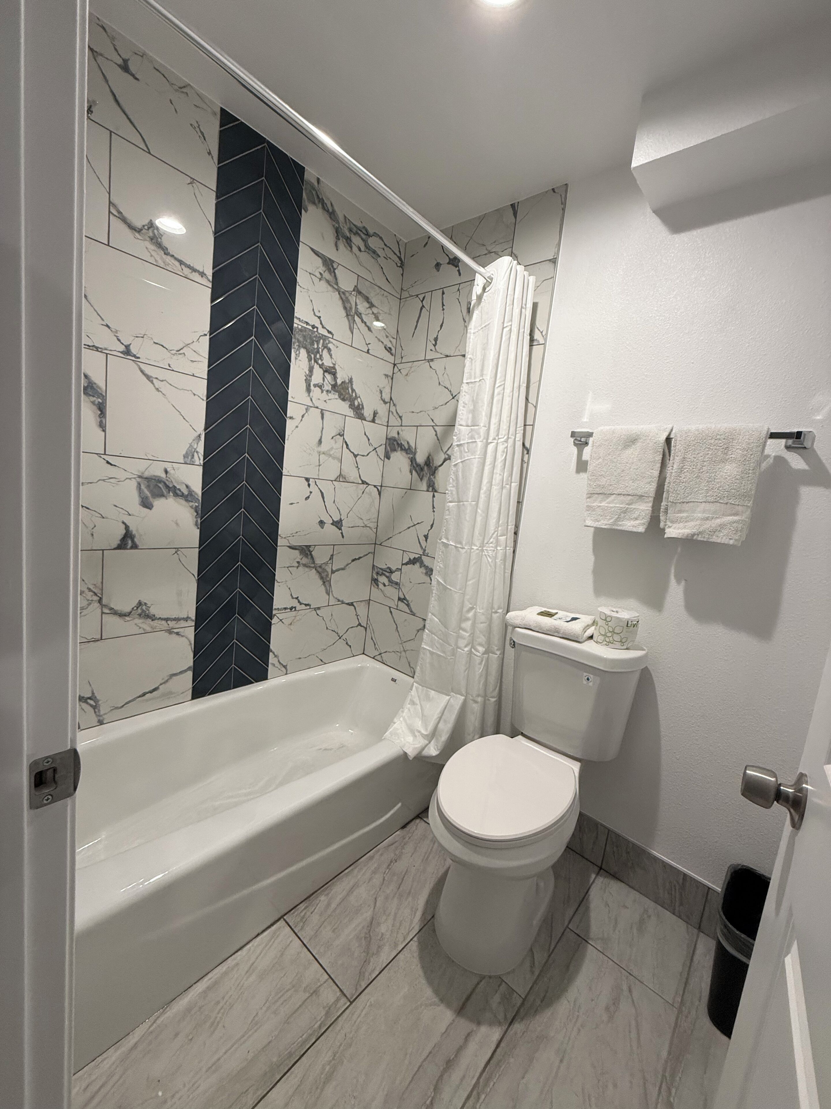 Combined shower/bathtub, towels, soap, shampoo