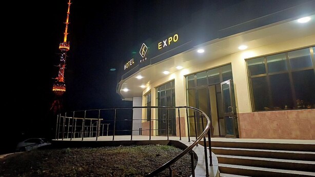 A hotel with a sign that reads "HOTEL EXPO" and a spiral staircase leading to the entrance. - EXPO Hotel (Tashkent)