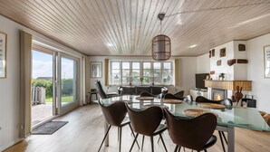 A modern dining area with a glass table, leather chairs, and a fireplace. - Pet friendly home in Slagelse with WiFi (Slagelse)