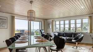 A modern dining area with a glass table, leather chairs, and a view of the sea. - Pet friendly home in Slagelse with WiFi (Slagelse)