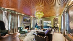 A spacious living room with a fireplace, modern furniture, and a wooden ceiling. - 2-level Spacious loft   with pool, private patio, and historic charm. (Dallas)
