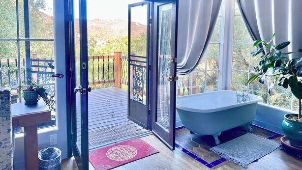 A bathroom with a bathtub, a shower, and a large window with curtains. - Peaceful LA Retreat w/ King Bed, Hot Tub and Mountain Views! Enjoy the Outdoors (Topanga)