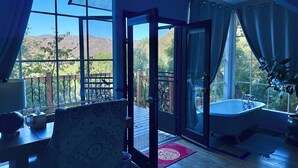 A room with a large window, a bathtub, and a wooden deck. - Peaceful LA Retreat w/ King Bed, Hot Tub and Mountain Views! Enjoy the Outdoors (Topanga)