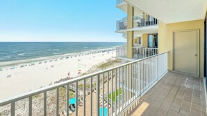A balcony with a view of a beach and ocean. - Romar Place 702 | Spectacular Gulf Views Oceanfront Condo | Beach Getaways (Orange Beach)
