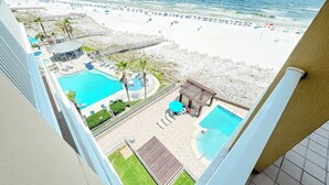 A resort with a pool area, beach access, and a view of the ocean. - Romar Place 702 | Spectacular Gulf Views Oceanfront Condo | Beach Getaways (Orange Beach)