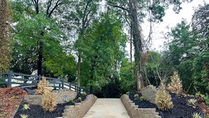 A concrete pathway flanked by stone steps and landscaped areas with plants. - Stylish 2BRM APT: Putting Green: 1mi Masters: 2mi Medical Center (Augusta)