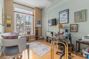 Relax in a spacious room with a comfortable seating area and a desk for productivity.