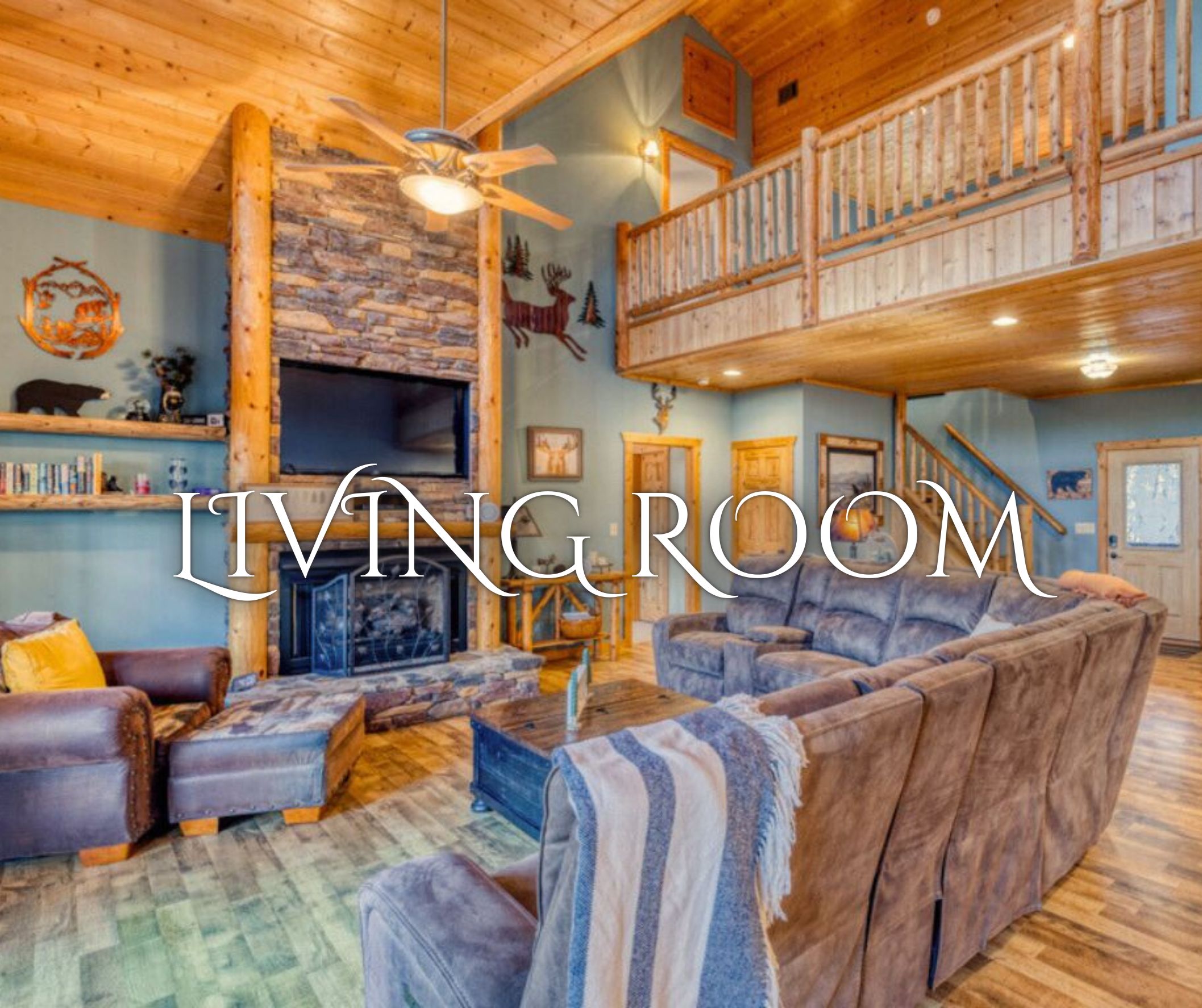 A spacious living room with a fireplace, a balcony, and a high ceiling.