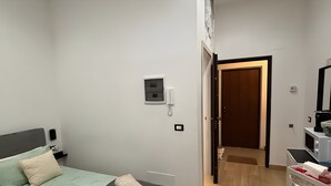 Et moderne hotelværelse med seng, sengebord og et skrivebord.