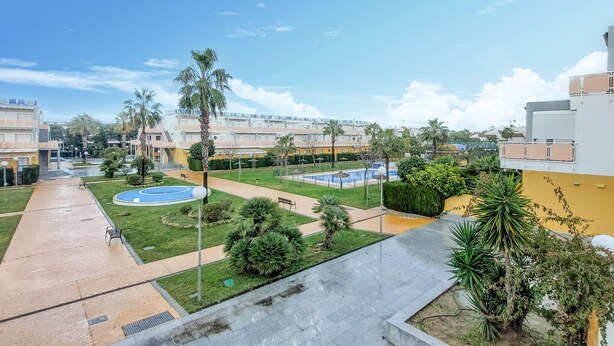 A residential area with multiple apartment buildings, a central courtyard with a swimming pool, and surrounding greenery.