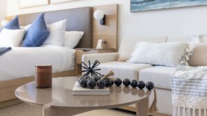 A modern hotel room with a neatly made bed, a bedside table with a lamp, and a view of the ocean through the window. -  3012 - Studio in front of Kaseya Center with Pool and Gym (Miami)