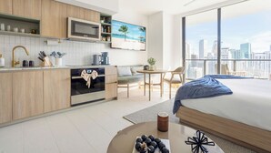 A modern hotel room with a kitchenette, a large bed, a city view, and a balcony. -  3012 - Studio in front of Kaseya Center with Pool and Gym (Miami)