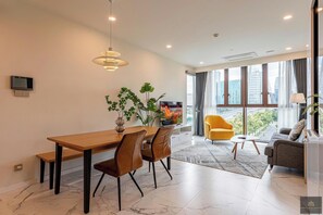 Presidential Apartment, 2 Bedrooms, Balcony, City View | Living area | 24-inch flat-screen TV with satellite channels, books - Metropole Residences Luxury Suite (Ho Chi Minh City)