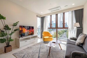Presidential Apartment, 2 Bedrooms, Balcony, City View | Living area | 24-inch flat-screen TV with satellite channels, books - Metropole Residences Luxury Suite (Ho Chi Minh City)