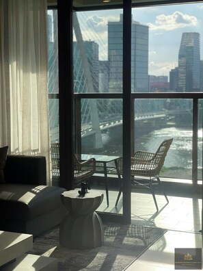 Luxury Apartment, 1 Bedroom, Balcony, City View | Living area | 24-inch flat-screen TV with satellite channels, books - Metropole Residences Luxury Suite (Ho Chi Minh City)