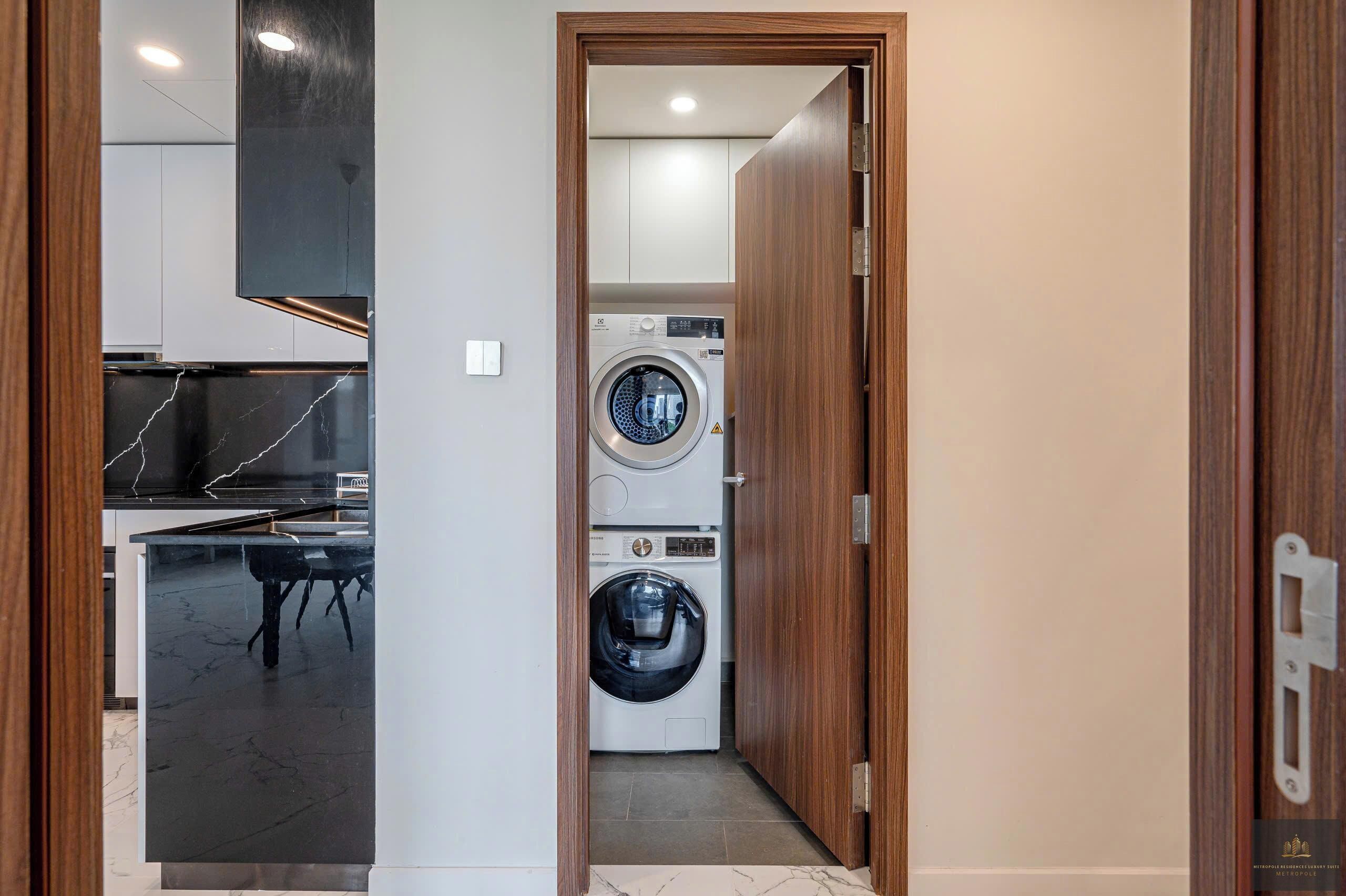 A laundry room with two washing machines and a table.