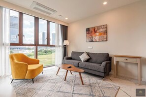 Presidential Apartment, 2 Bedrooms, Balcony, City View | Living area | 24-inch flat-screen TV with satellite channels, books - Metropole Residences Luxury Suite (Ho Chi Minh City)