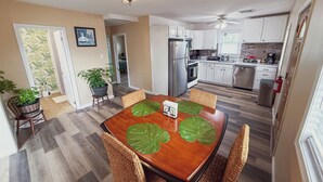 A dining area with a wooden table, four chairs, and a ceiling fan. - Relaxing 2BR/2BA Entire House, Short Drive from Wildwood & Cape May Beaches (Middle Township)